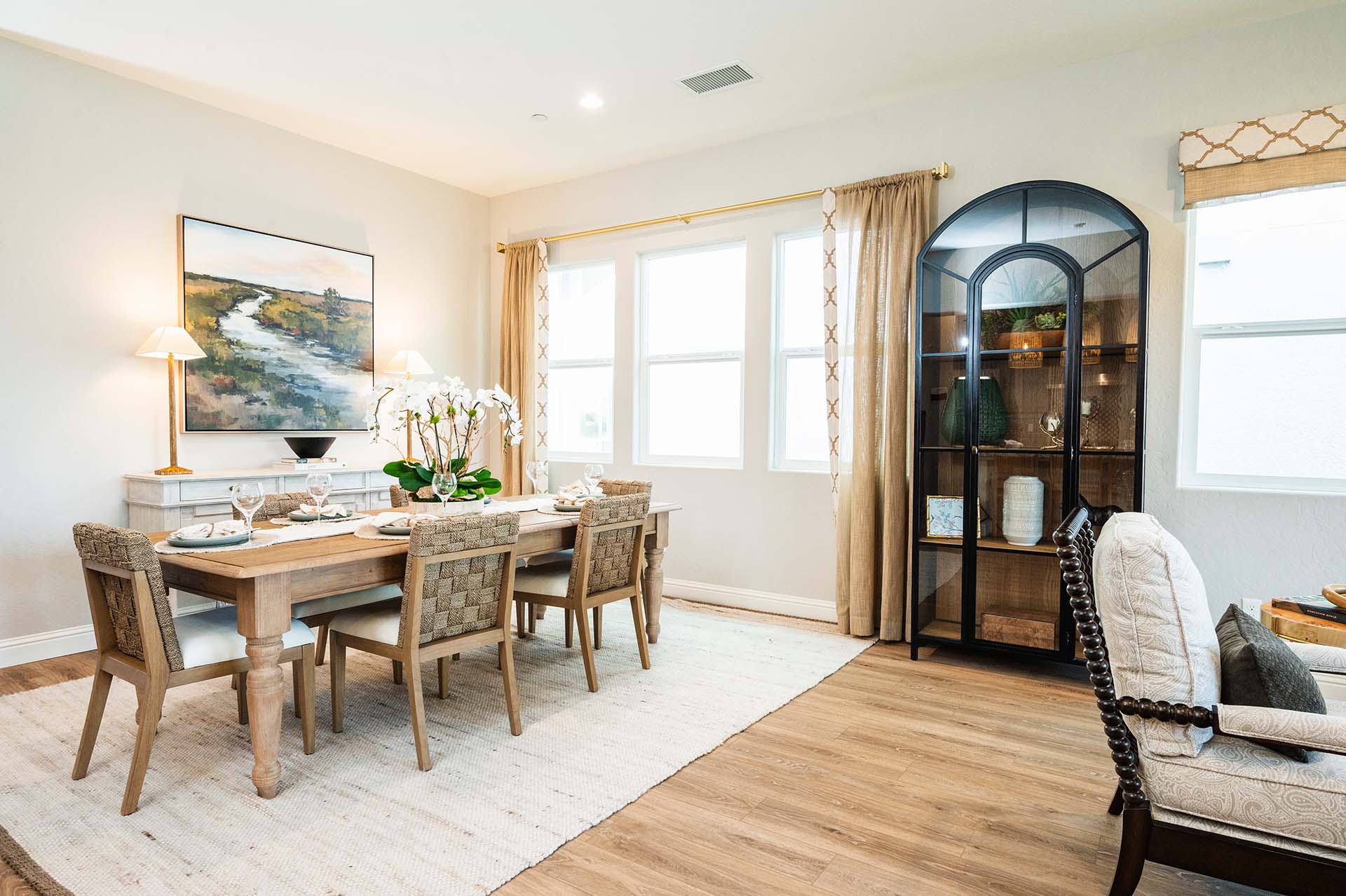 A Bonadelle Neighborhoods dining room with wood flooring and abundant natural light.
